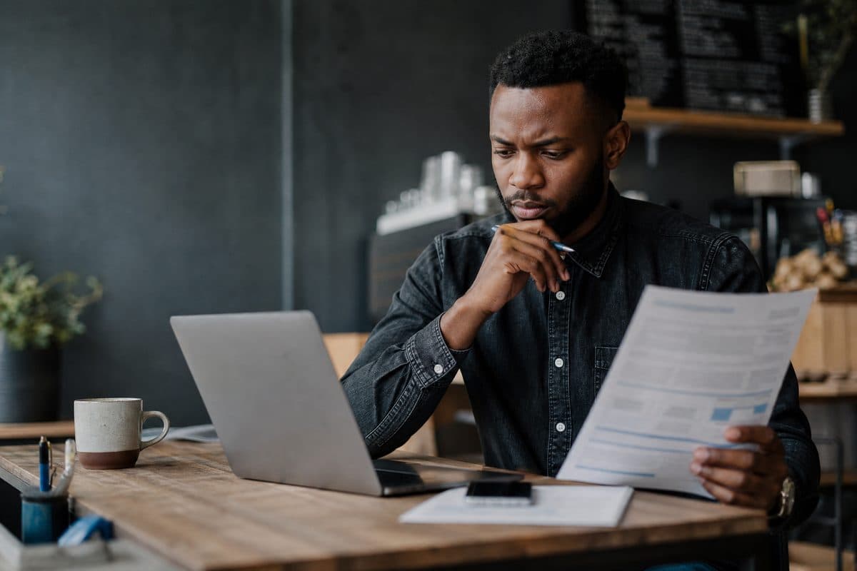 Small business owner reviewing growth plans on a laptop