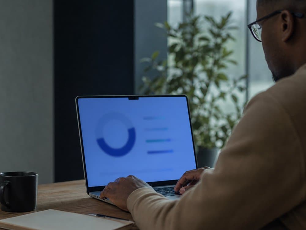 Business professional reviewing connectivity and billing data on a laptop